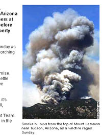 Smoke billows from the top of Mount Lemmon near Tucson, Arizona, as a wildfire rages Sunday.