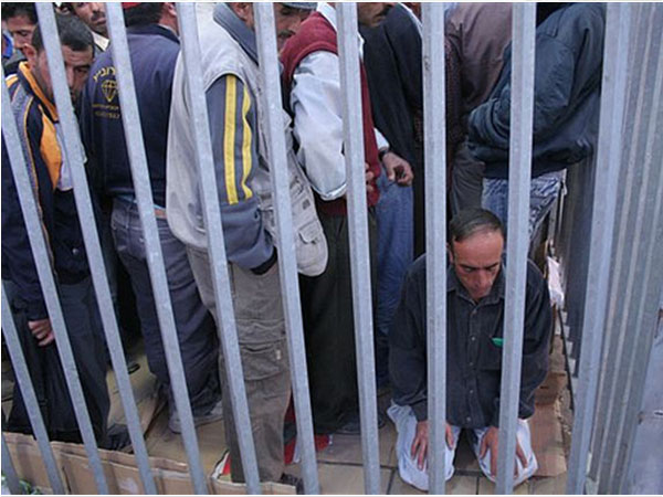 Bethlehem Crossing, 2008, man praying at 5:30am. Courtesy of MachsomWatch