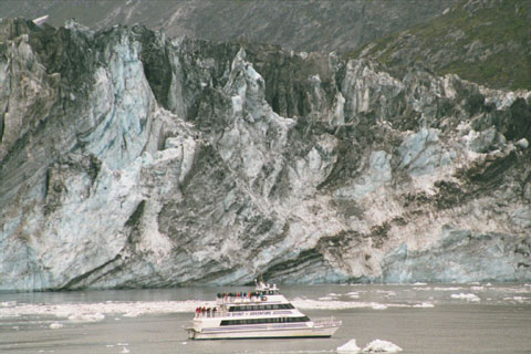  Small boat next to glacier face