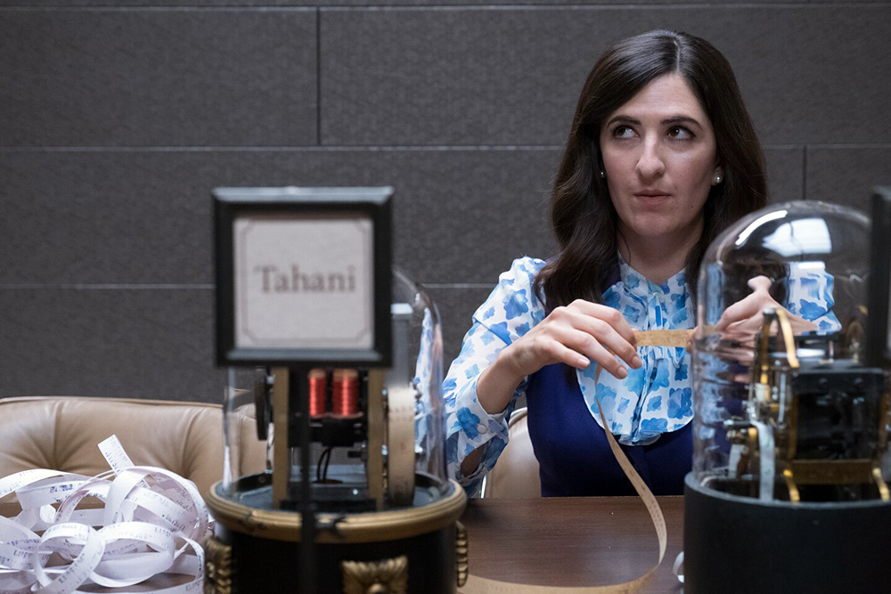 Woman looks worried holding ticker tape.