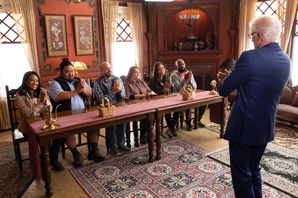 People at a table clapping.