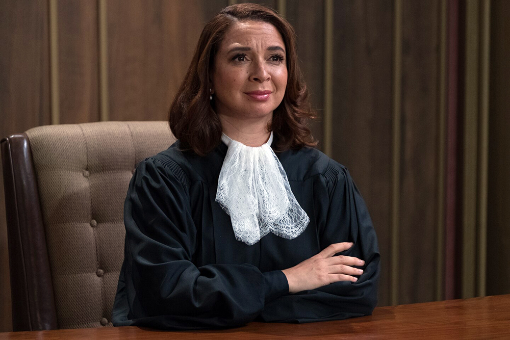 A judge sits at her desk.