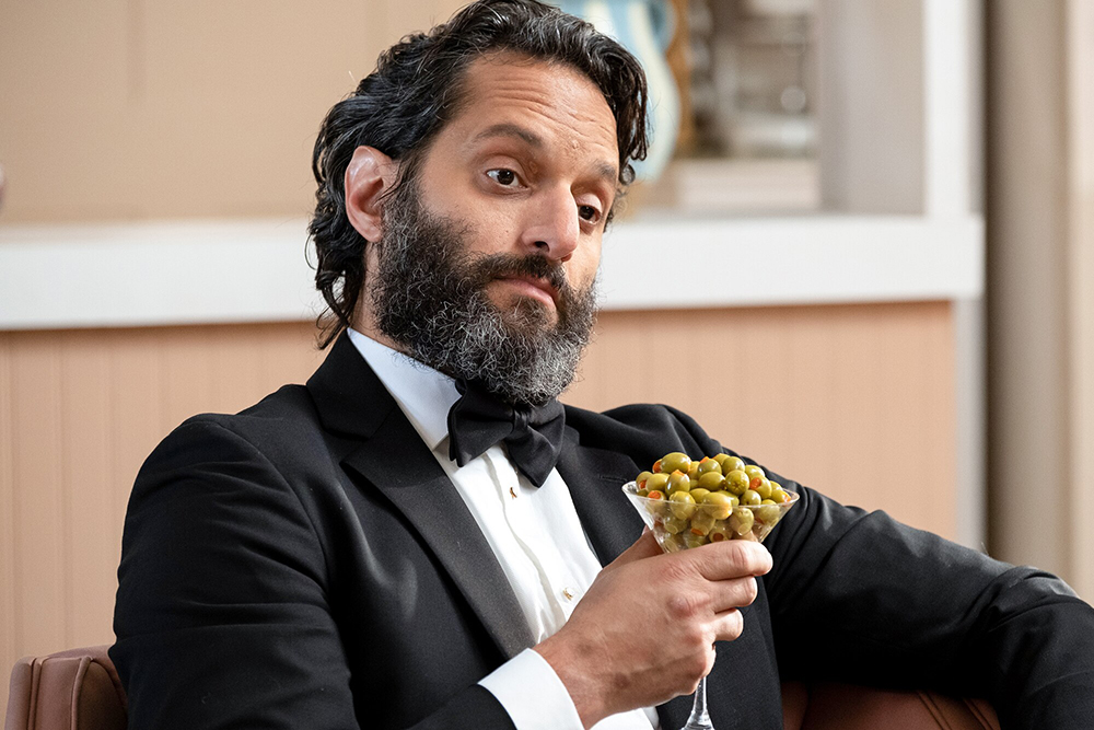 Man enjoying cocktail of olives.