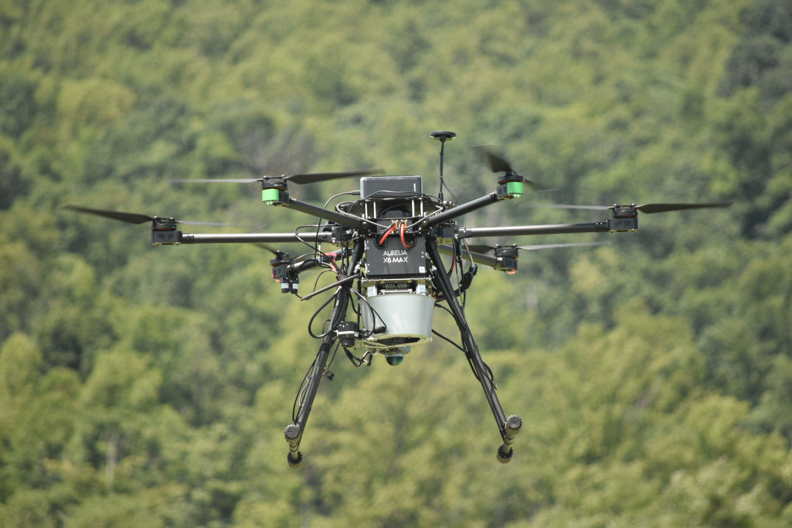 VISTA hexarotor flying over a field with thermal, hyperspectral, and LiDAR sensors
